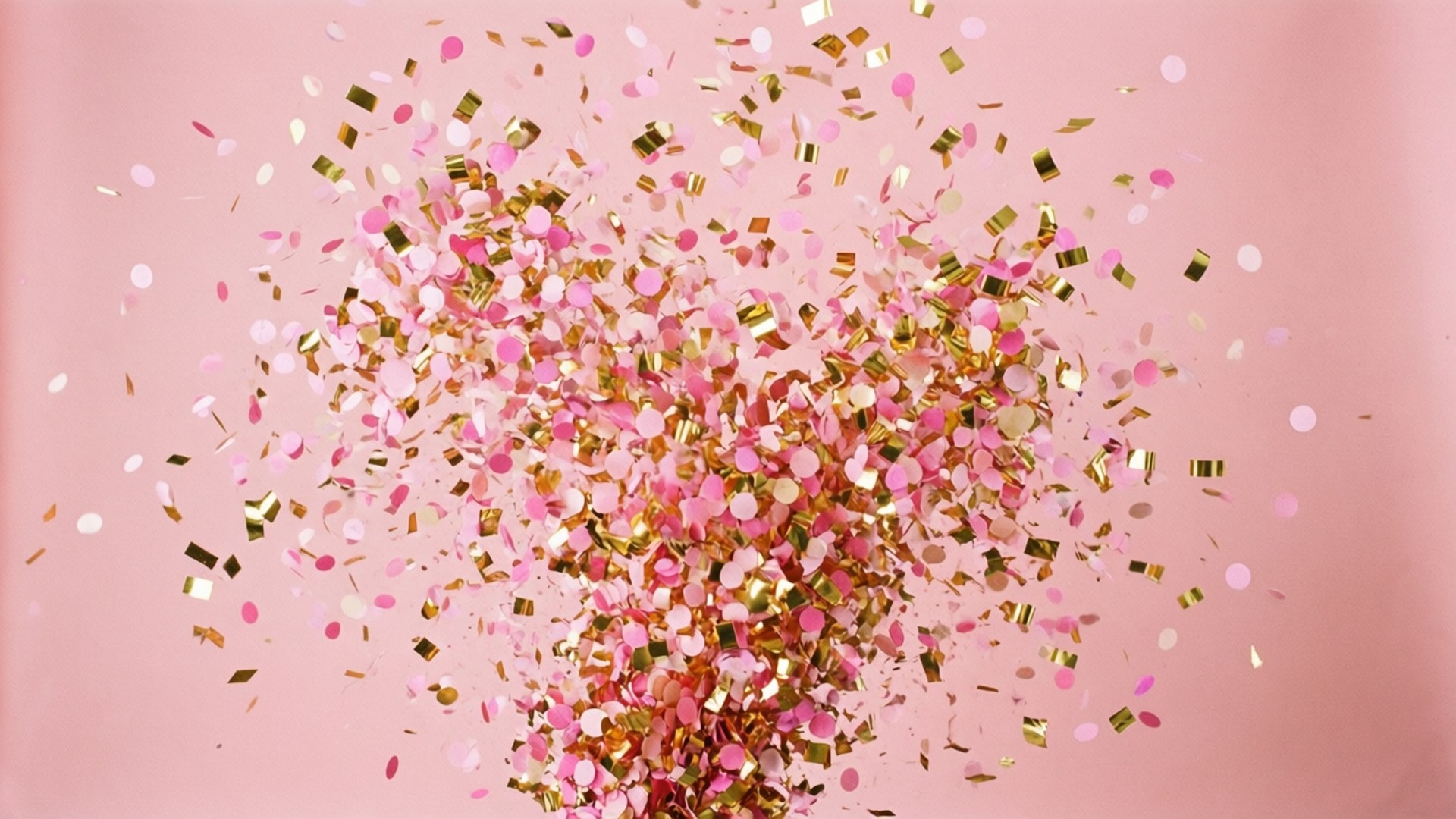 Confetti Celebration 壁紙 — 粉紅色和金色紙屑在柔和的粉紅色背景上爆發，營造出節日慶祝的氣氛。