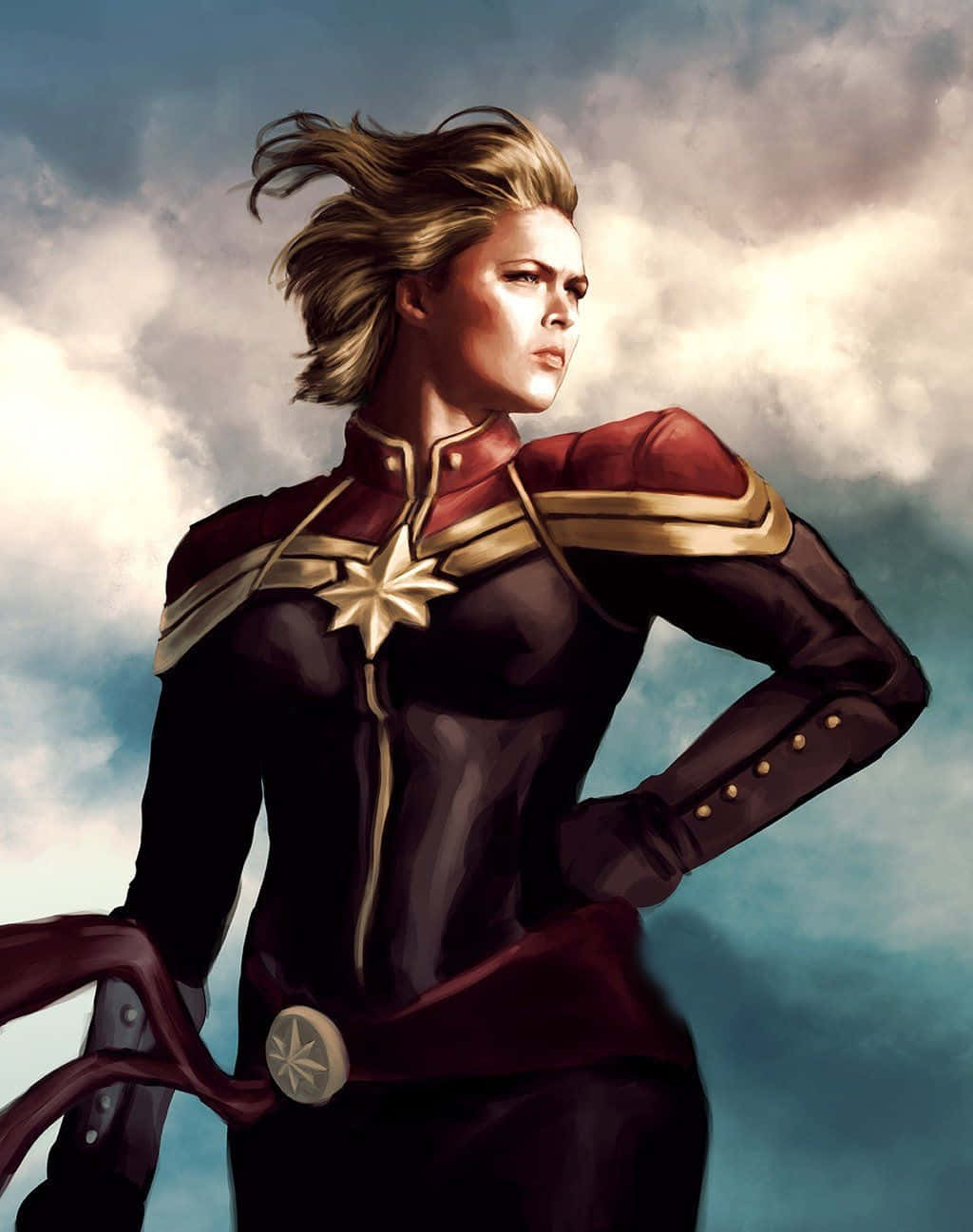 Marvel Movie 桌布 壁紙 — Captain Marvel 自信地站在戲劇性的多雲天空下，風吹動她的頭髮。