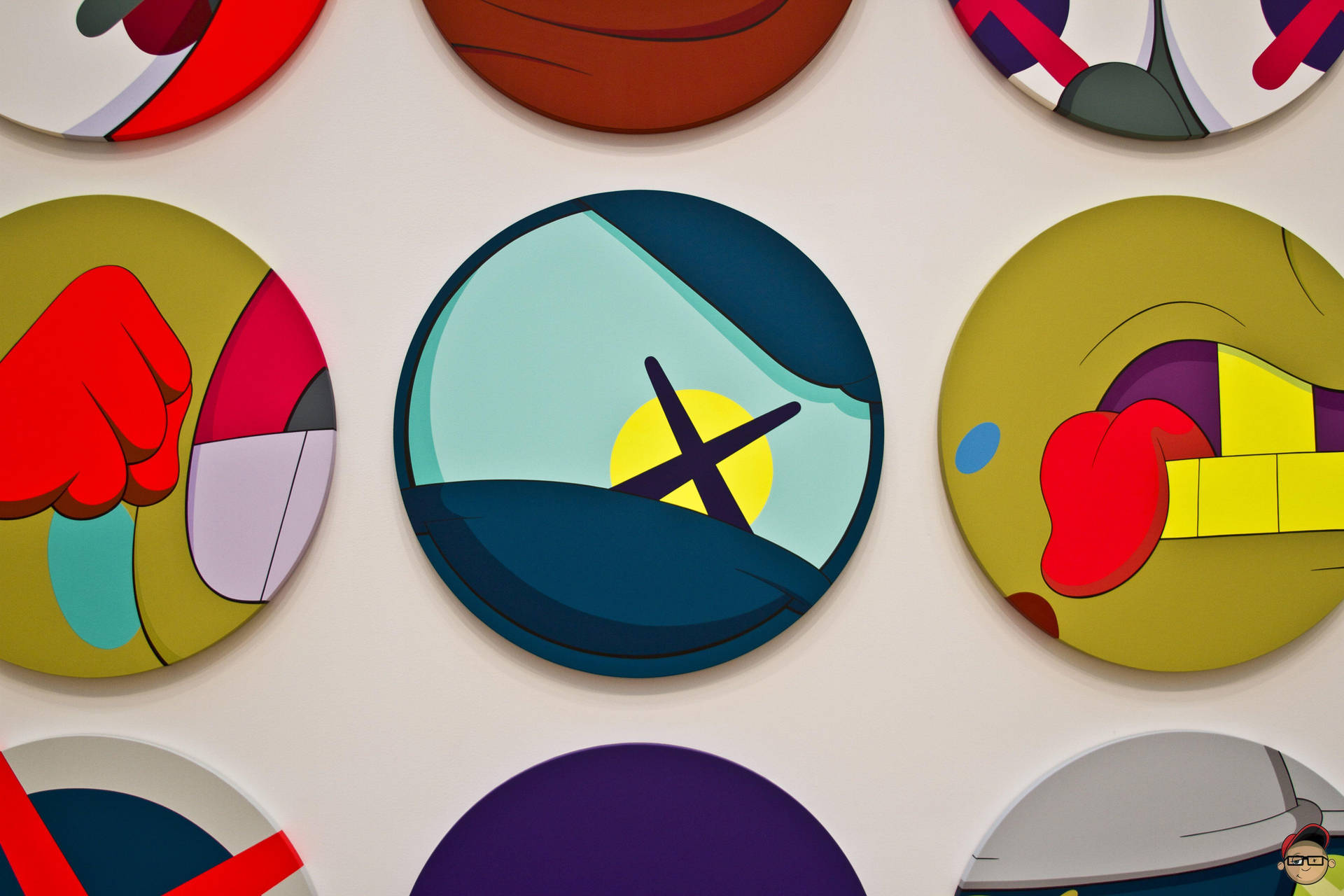 圓形抽象畫，色彩大膽，安裝在白色牆壁上。 — Kaws 壁紙