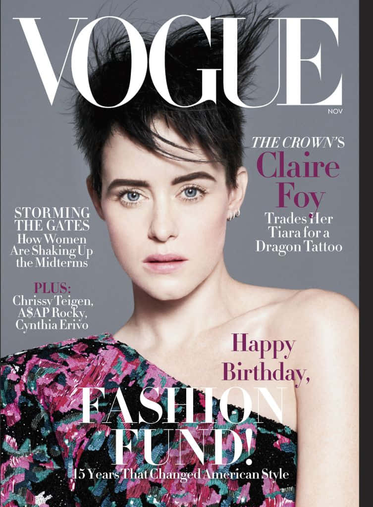 雜誌 桌布 壁紙 — Claire Foy 留著短黑髮，化著大膽妝容，在灰色背景前穿著鮮豔花卉單肩上衣，專注地凝視鏡頭。