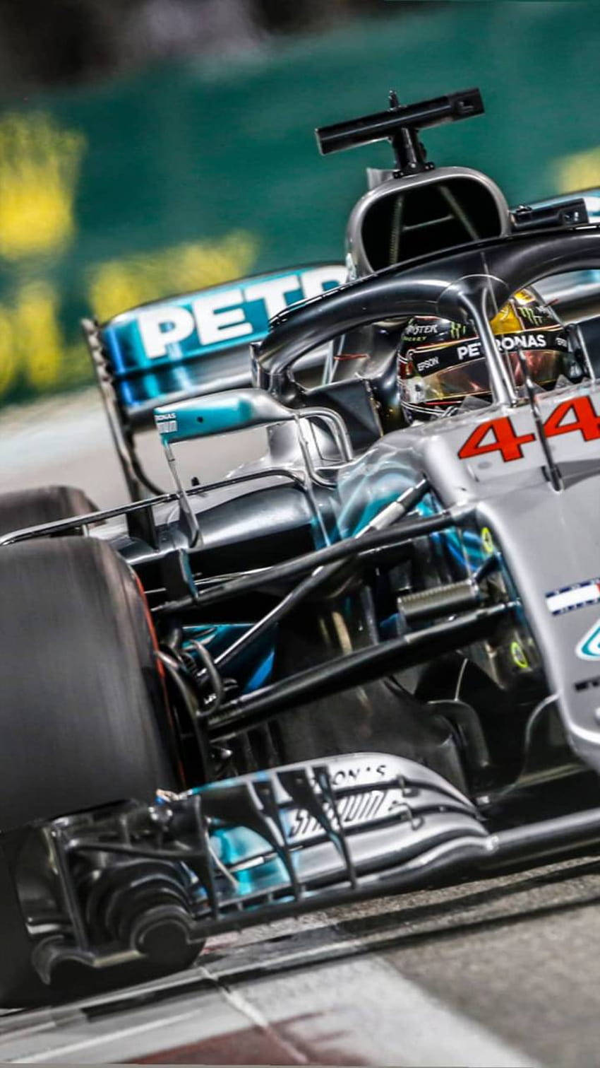夜間在賽道上疾馳的一級方程式賽車，可見贊助商標誌。 — F1 壁紙