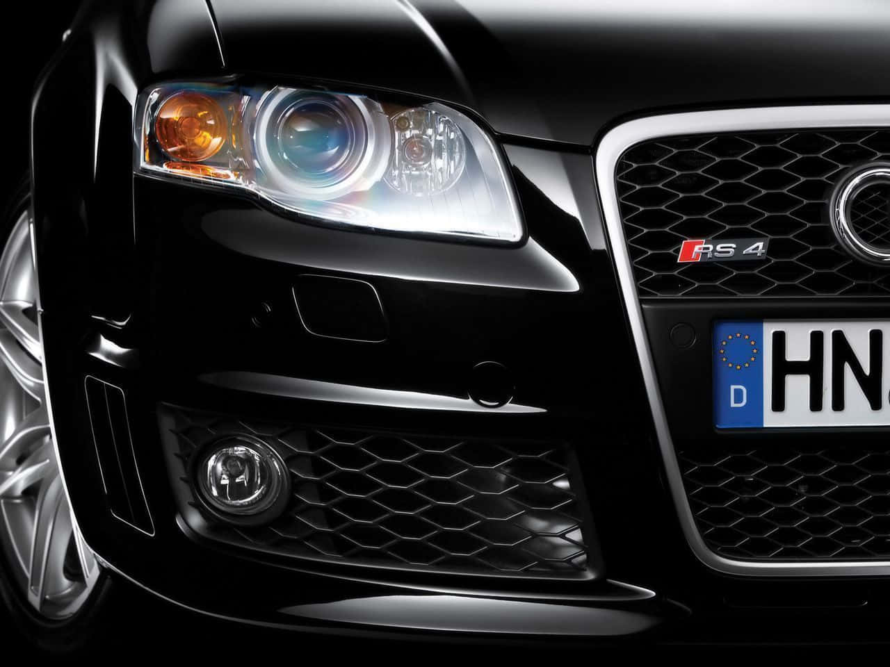 Audi Rs4 桌布 壁紙 — 黑色奧迪RS4前格柵和頭燈的緊密特寫，帶有德國車牌。