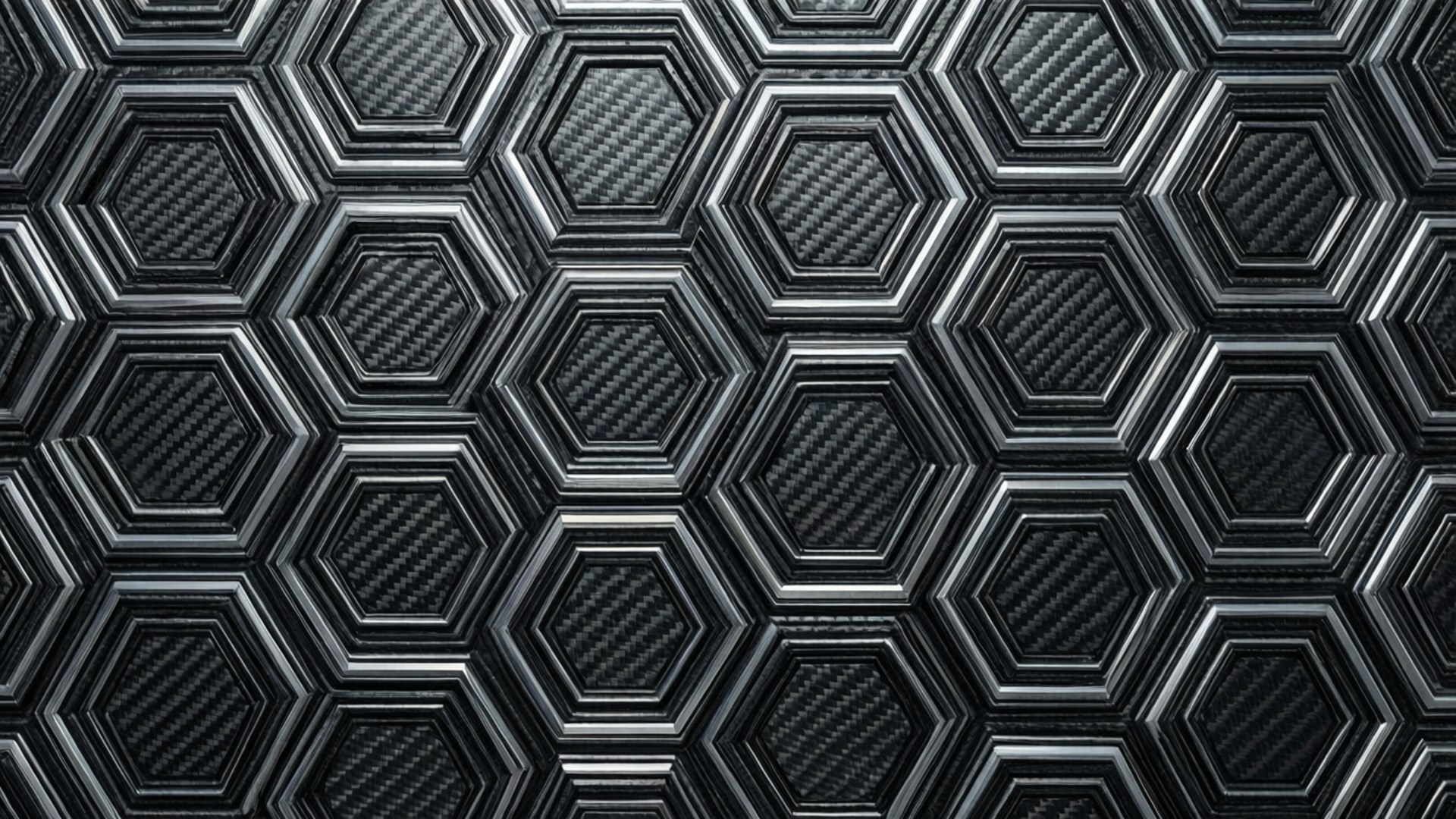 Hexagon Carbon Fiber 壁紙 — 黑色碳纖維表面的特寫，帶有凸起的六邊形圖案和金屬銀色邊框。