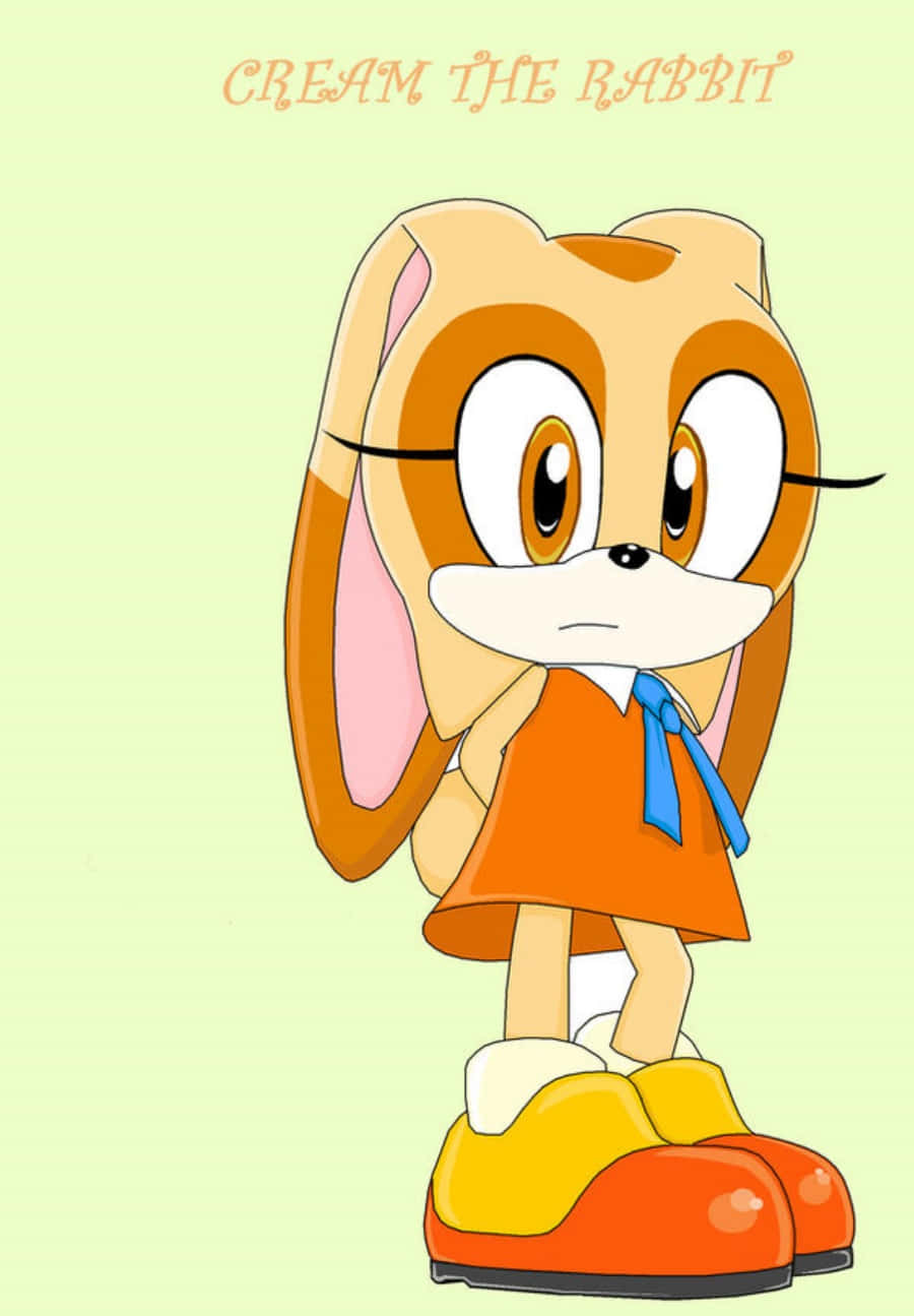 Cream The Rabbit 桌布 壁紙 — Cream the Rabbit 以愉快姿勢站立，身穿橙色連衣裙和彩色鞋子，背景為柔和綠色。