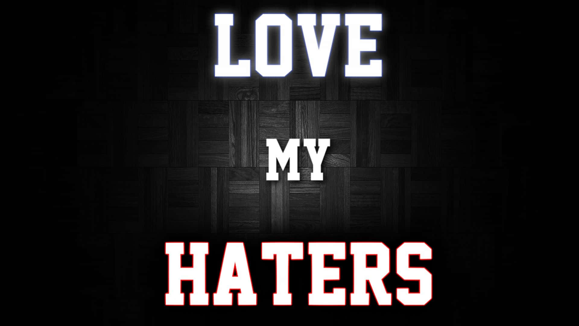  壁紙 — 大膽的白色和紅色文字在深色木地板背景上寫著 LOVE MY HATERS。