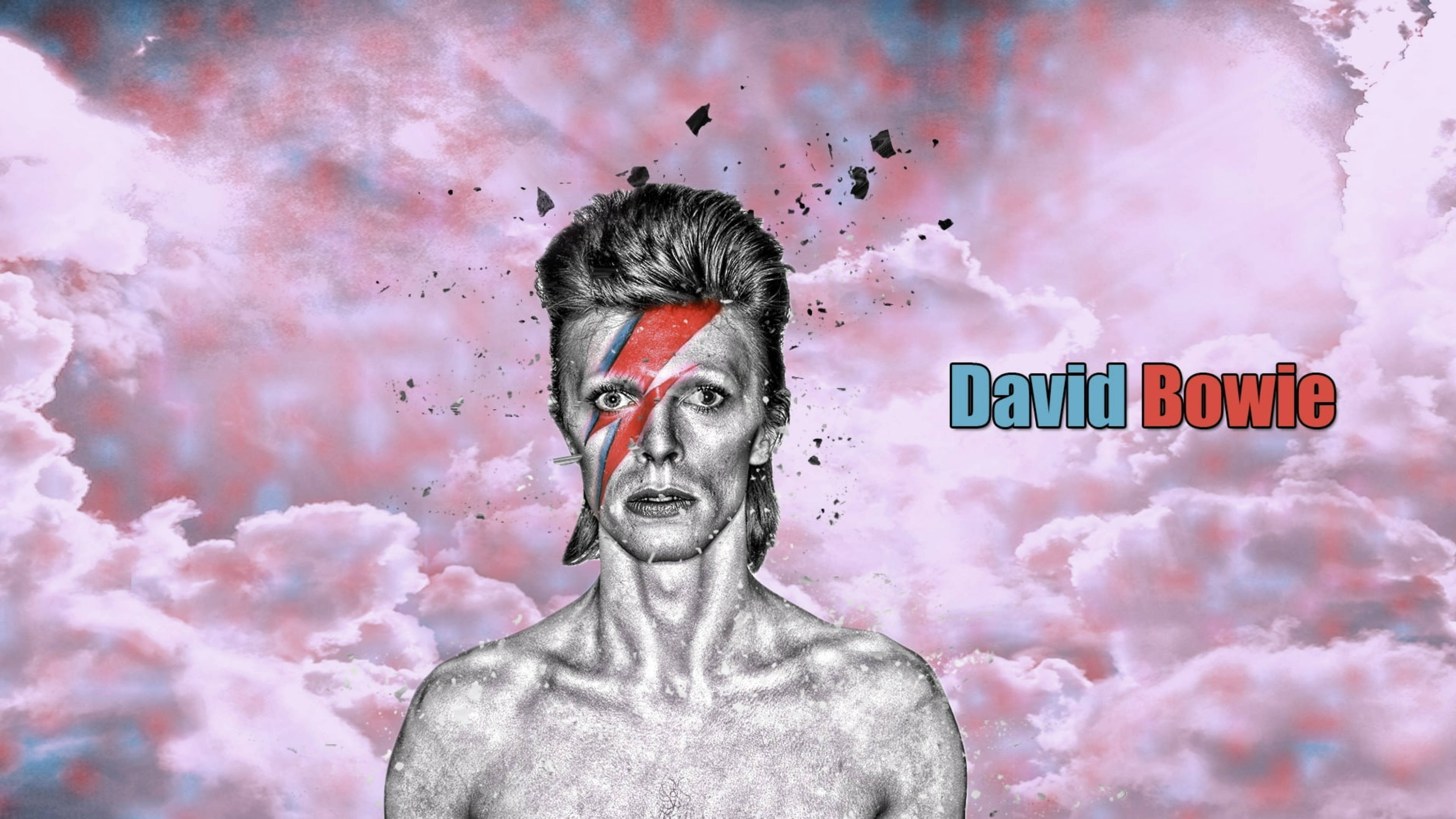 大衛·鮑伊 桌布 壁紙 — David Bowie 以標誌性的閃電妝容，站在超現實的粉藍色雲層天空前，周圍有破碎的碎片。