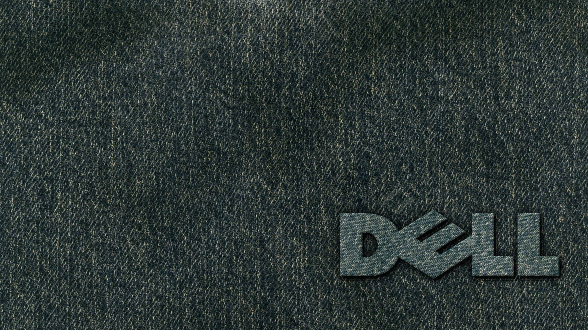 Dell 標誌刺繡在深色牛仔布紋理上。 — Dell 壁紙