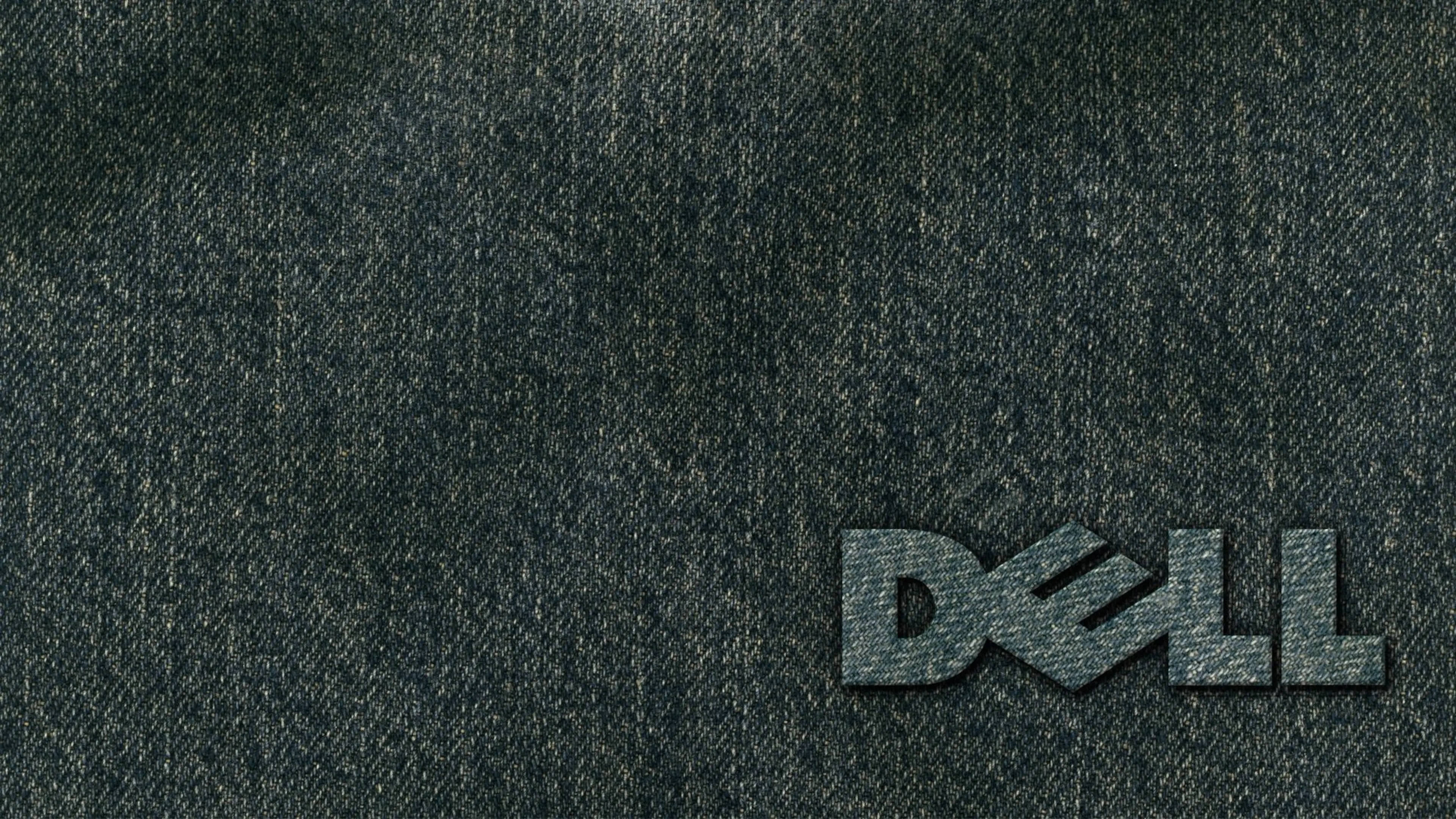 dell 4K 桌布 壁紙 — Dell 標誌縫在深色牛仔布上，帶有可見紋理和細微的縫線細節。