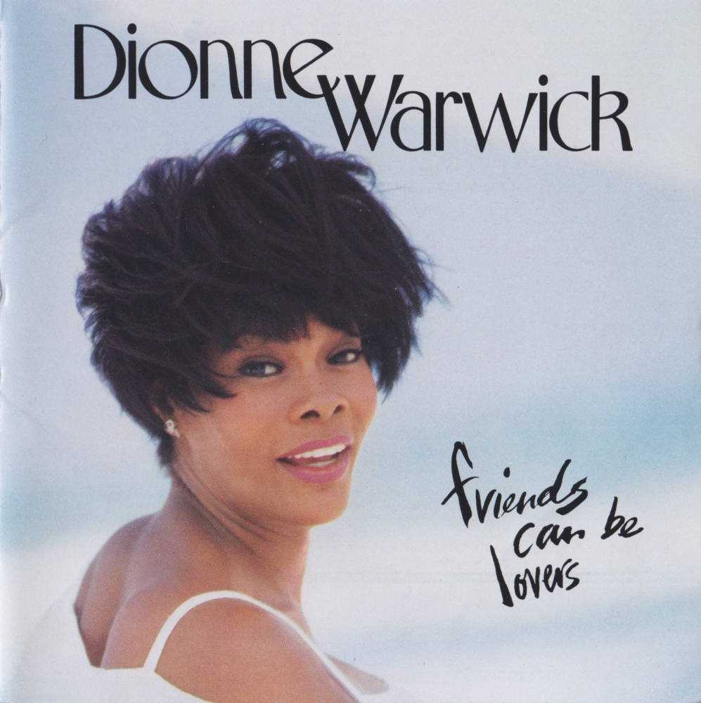 Dionne Warwick 身穿白色上衣微笑，帶有專輯標題文字 — 高解析度 壁紙