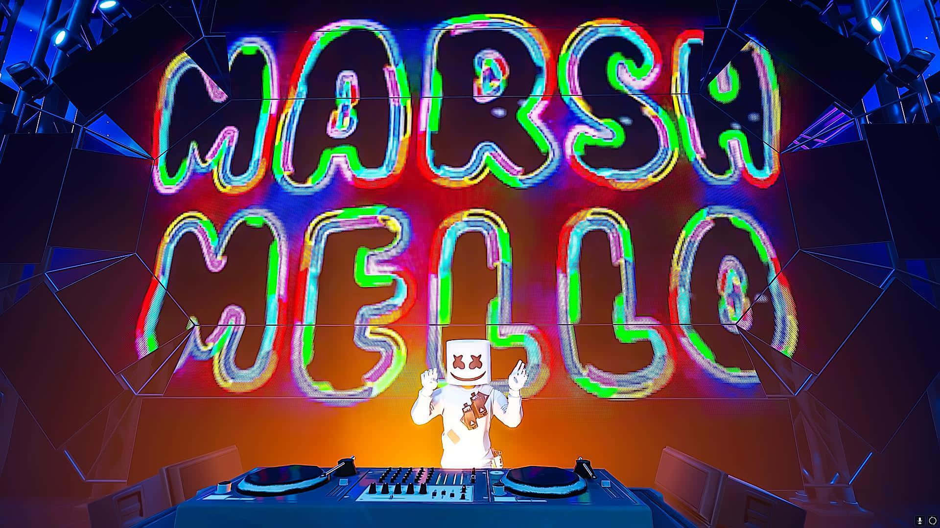 Marshmello 動態圖 桌布 壁紙 — DJ Marshmello 在一個未來主義的音樂會場景中，在一個帶有鮮豔彩虹輪廓的巨大發光霓虹燈牌下表演。