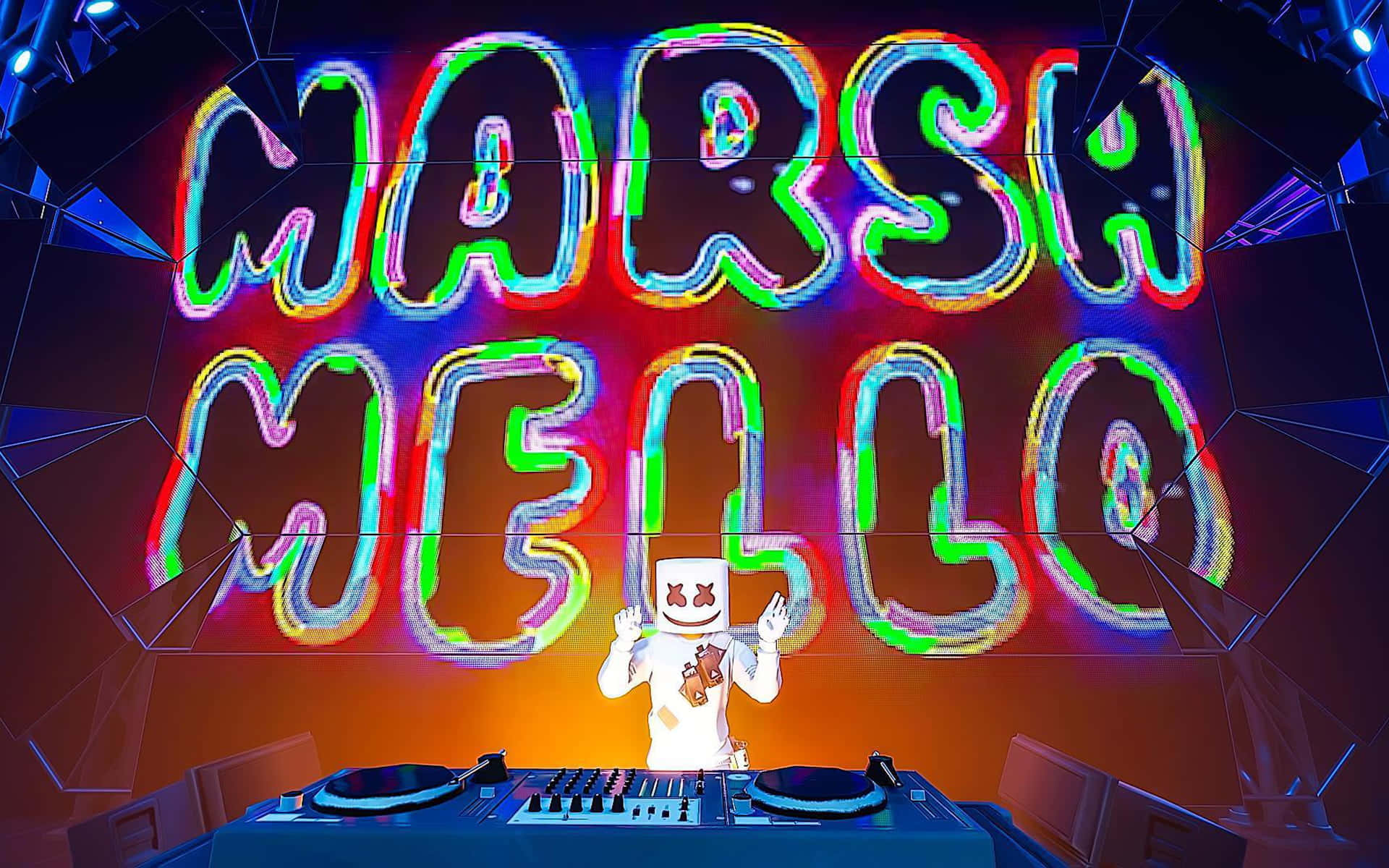 Fortnite Marshmello 桌布 壁紙 — DJ Marshmello 戴著他標誌性的白色頭盔，站在一個發光的DJ台後面，上方有一個巨大的彩色霓虹燈牌拼寫著他的名字。