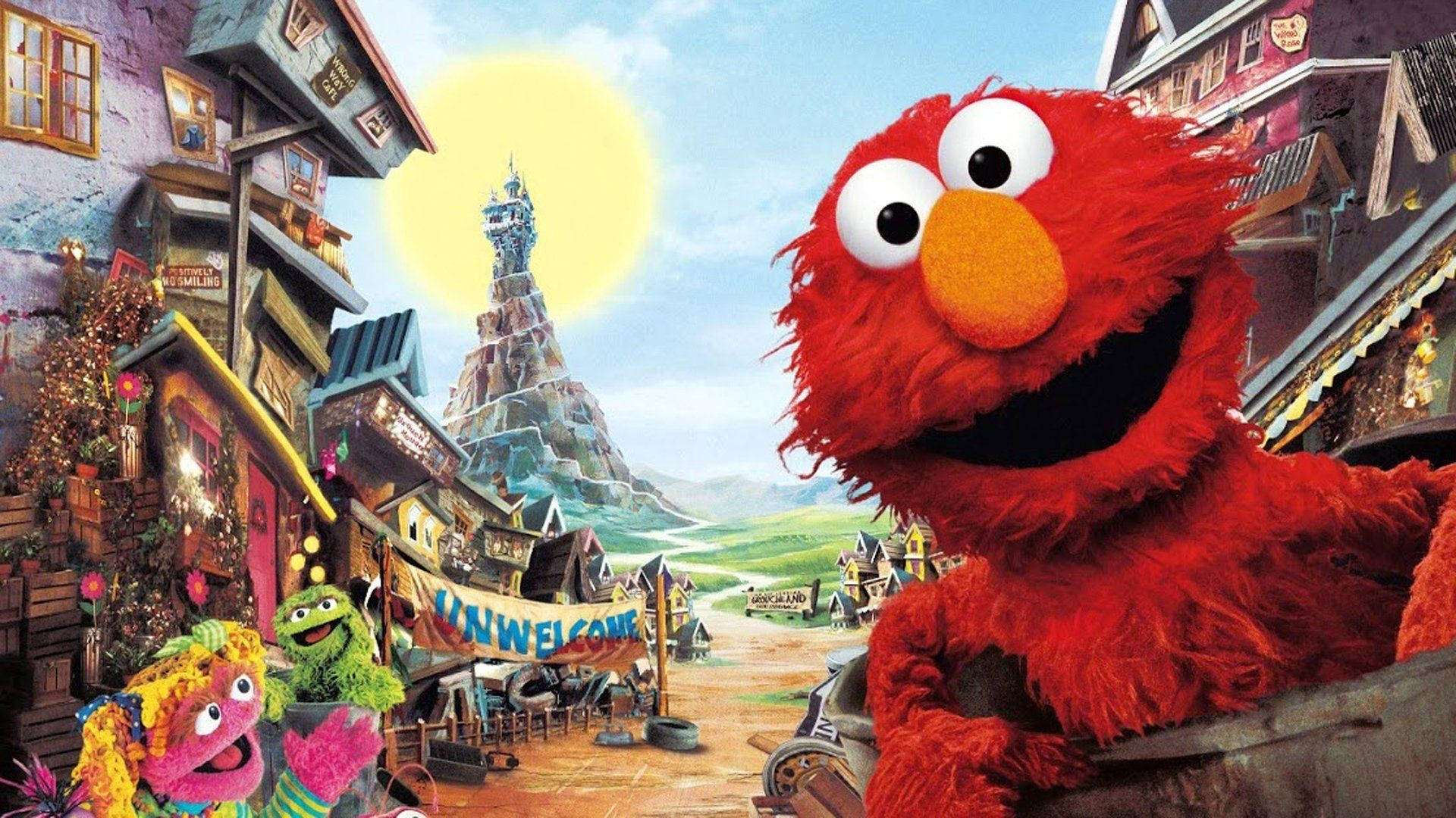 Sesame Street 桌布 壁紙 — Elmo 和朋友們在色彩繽紛、充滿奇想的村莊裡，在明亮的陽光下愉快地向觀眾打招呼。