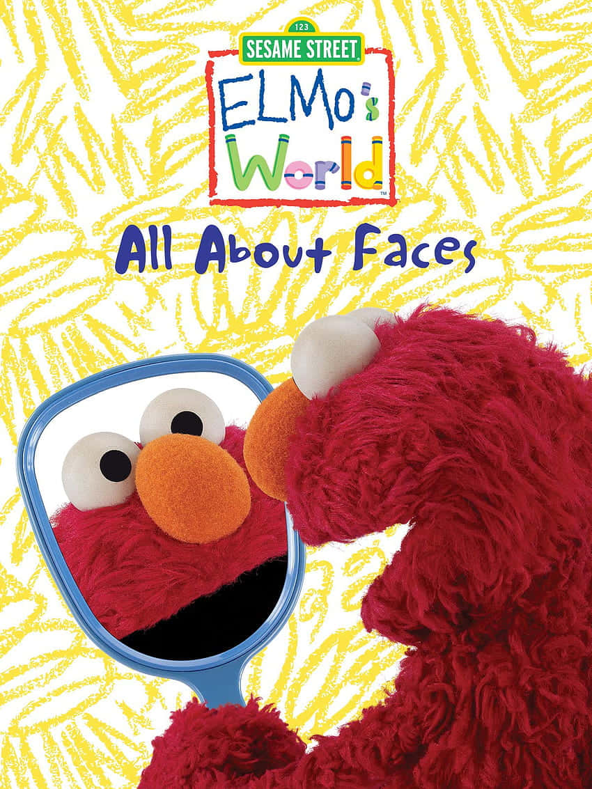 Elmo 桌布 壁紙 — Elmo 在黃色蠟筆畫的背景前，看著一個藍色手柄的鏡子，上面有 'Elmo's World All About Faces' 的文字。