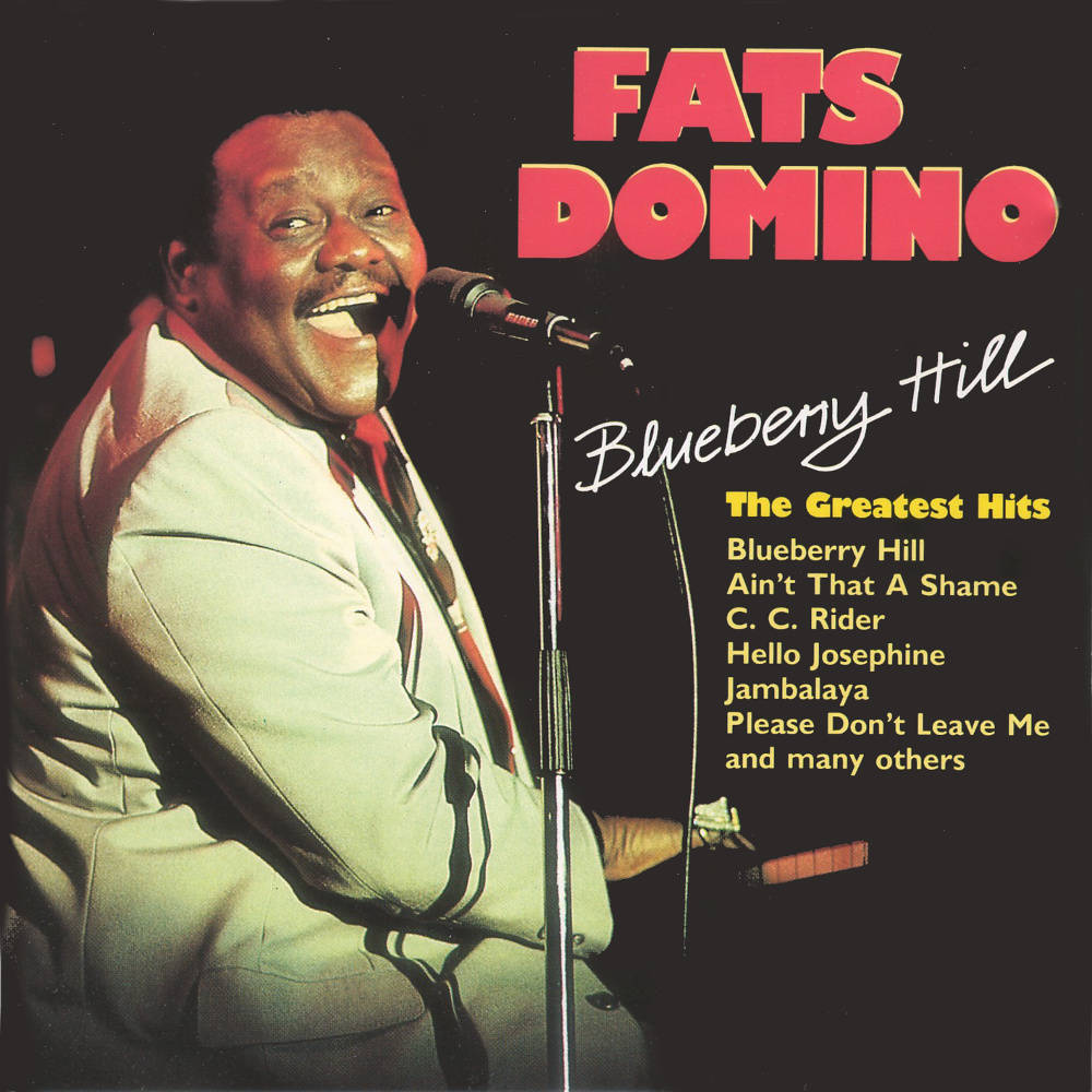Legend 桌布 壁紙 — Fats Domino 在復古專輯封面上微笑著對著麥克風唱歌，封面有粗體紅色文字。