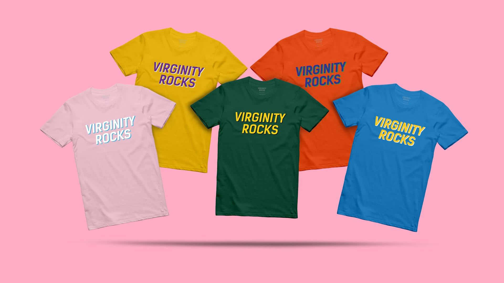  壁紙 — 五件色彩繽紛的T恤，上面印有「VIRGINITY ROCKS」字樣，漂浮在純粉紅色背景上。