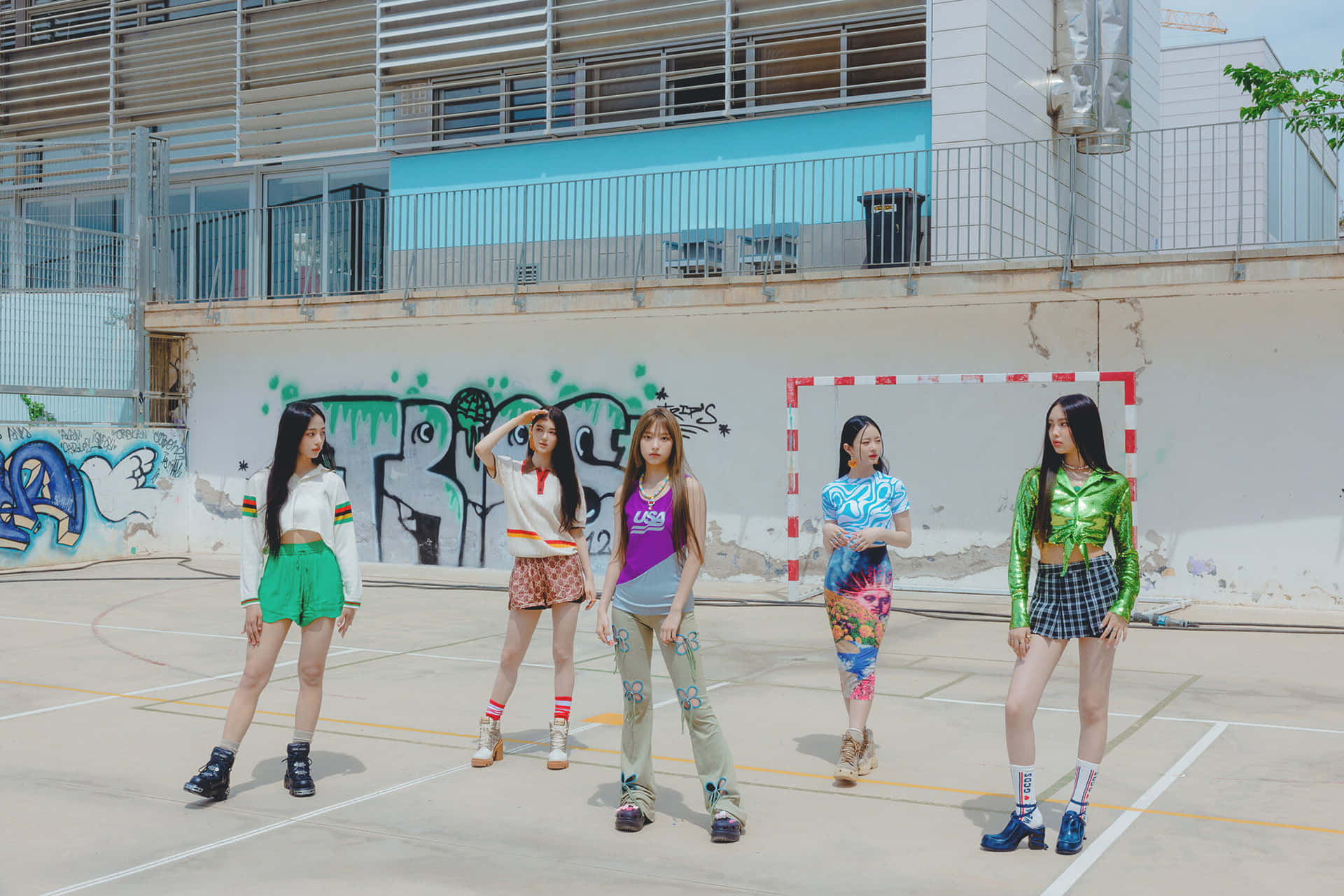  壁紙 — 五位時尚年輕女性在陽光明媚的城市籃球場上自信地擺姿勢，身後有塗鴉牆和球門柱。
