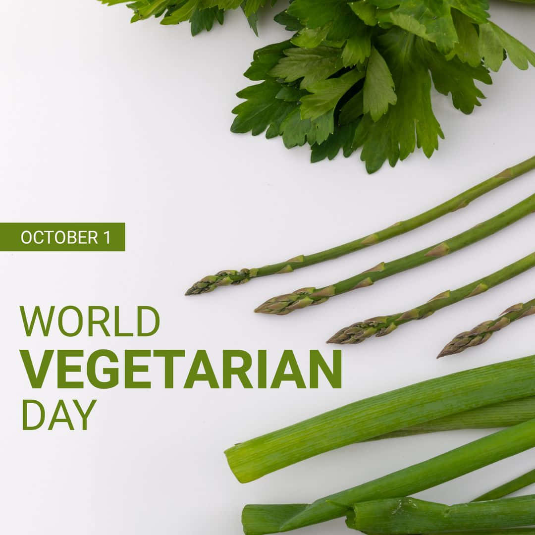  壁紙 — 新鮮青蘆筍和歐芹排列在白色背景上，帶有「World Vegetarian Day」文字。