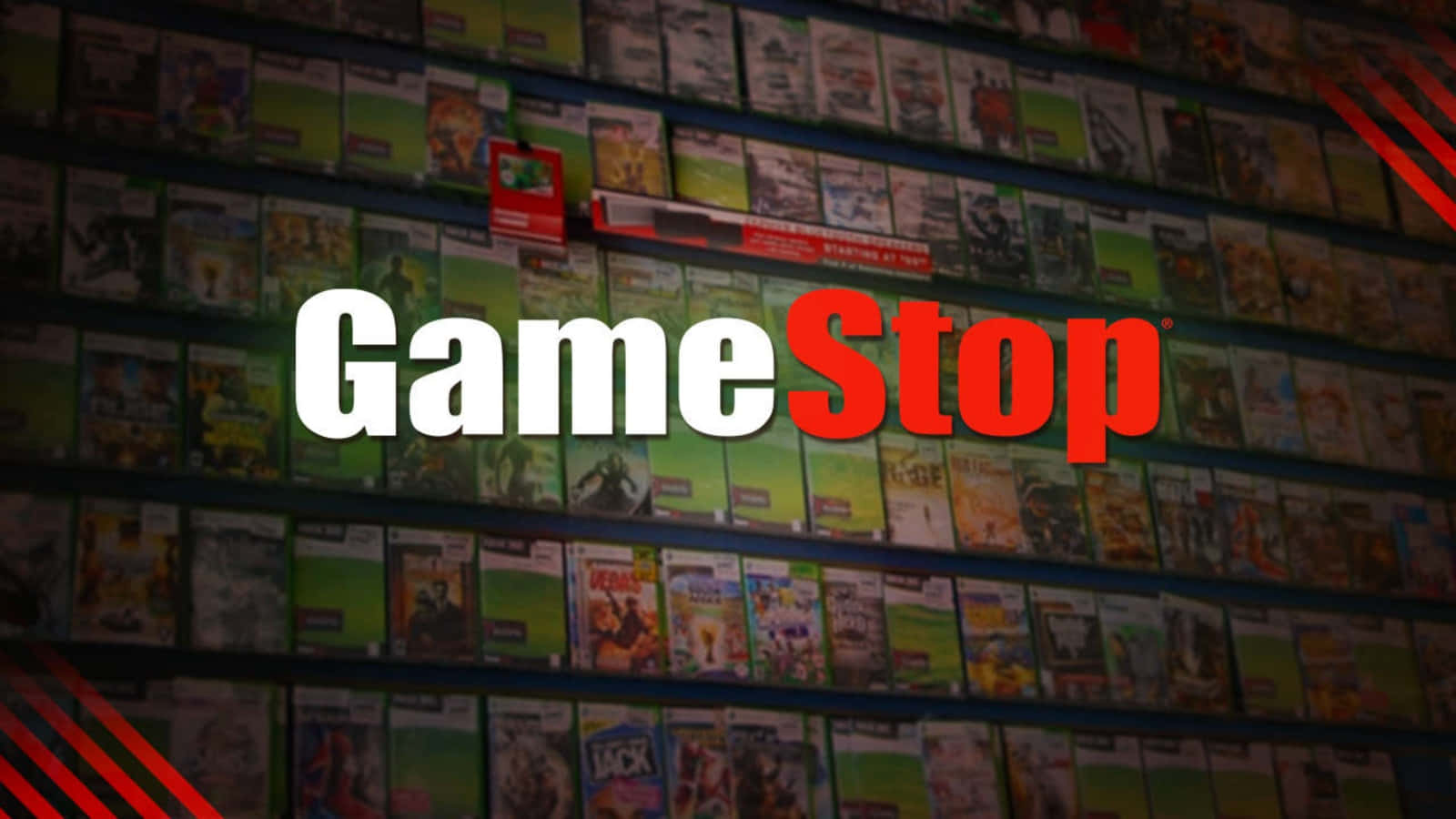 GameStop 桌布 壁紙 — GameStop 標誌以粗體白色和紅色字母居中顯示在昏暗商店中裝滿彩色電玩遊戲盒的貨架上。