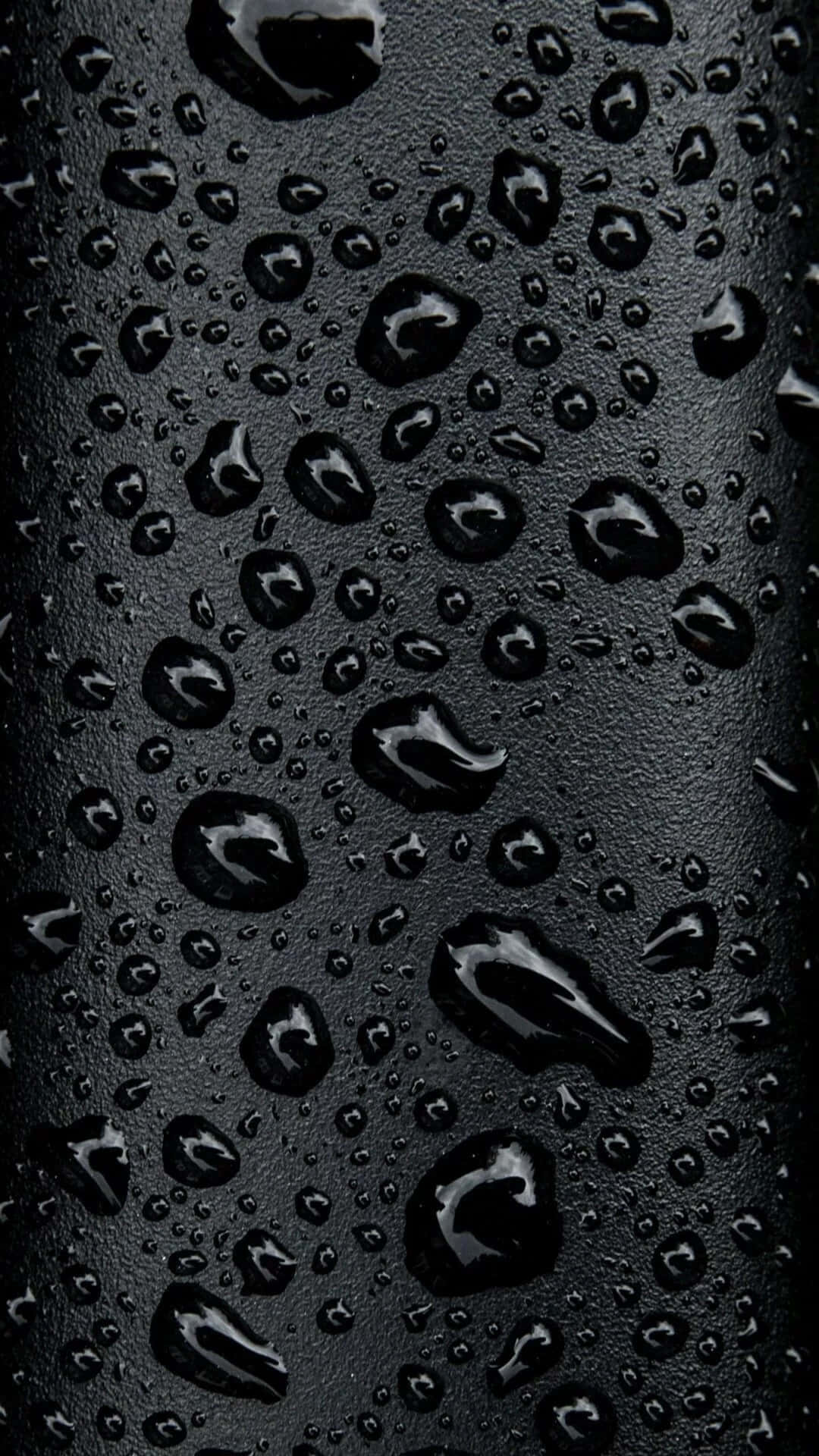 黑色紋理表面上的水珠特寫 — iPhone 13 Pro 壁紙