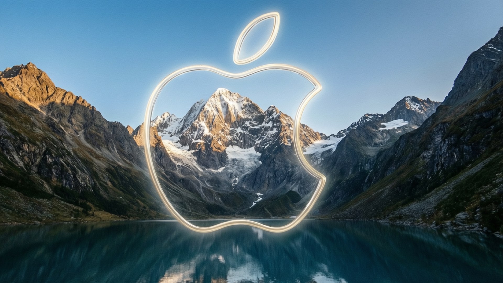 Mountain Inside Apple 壁紙 — 發光的Apple標誌框住了一個被雪覆蓋的山脈，倒映在平靜的藍色湖面上，天空晴朗。