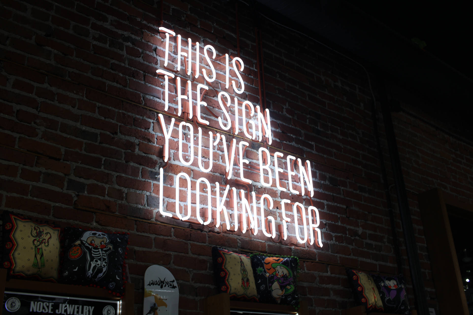 磚牆上的霓虹燈牌寫著「This is the sign you've been looking for」 — 霓虹 壁紙