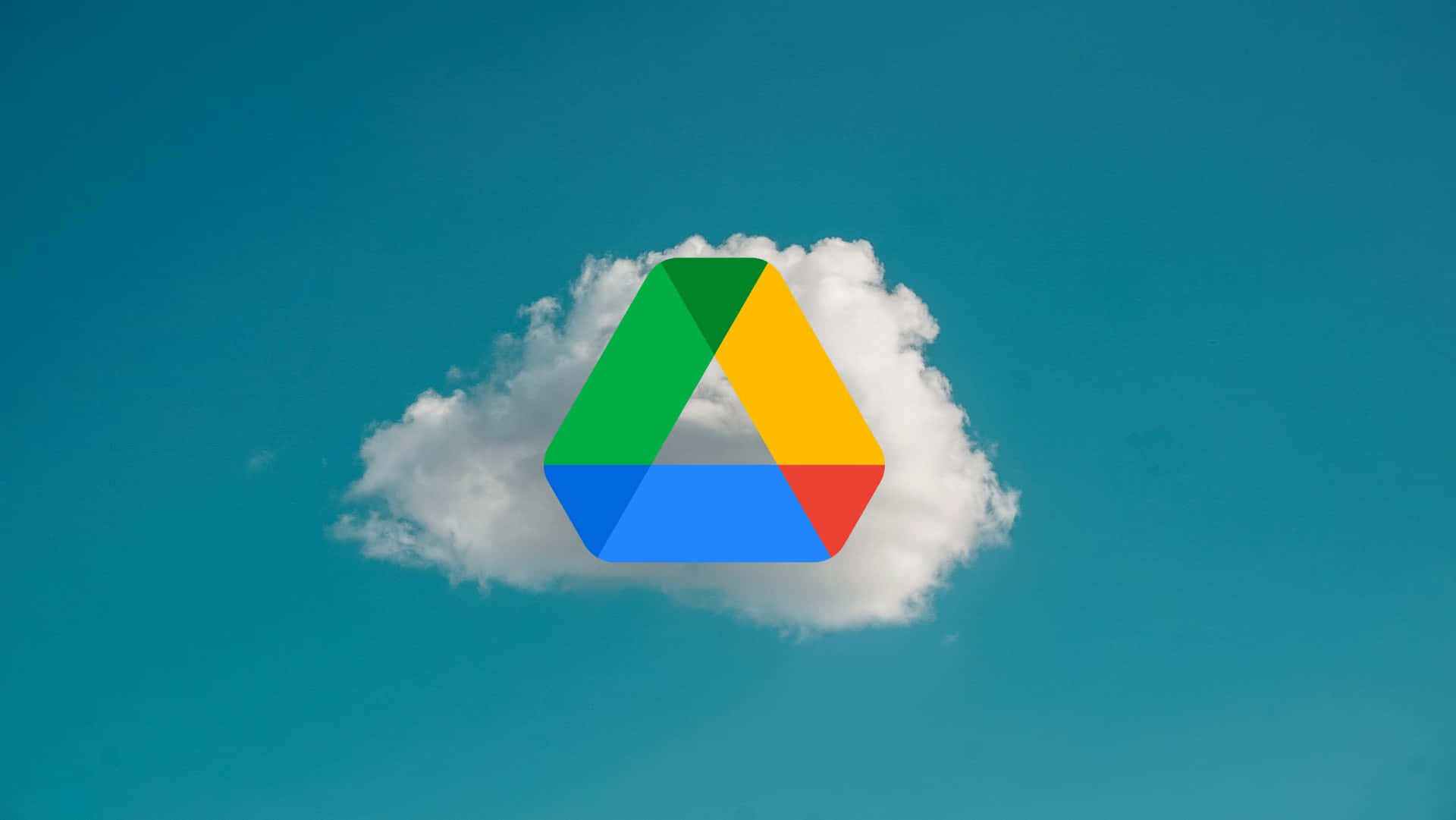 科技動圖 桌布 壁紙 — Google Drive 標誌從一朵蓬鬆的白雲中浮現，背景是清澈的藍天。