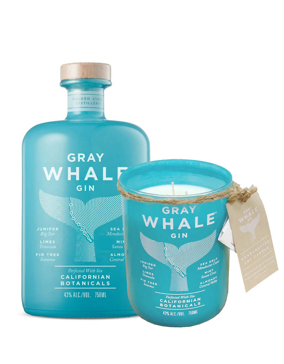 bottle 桌布 壁紙 — Gray Whale Gin 的藍綠色酒瓶和配對蠟燭，帶有鯨魚尾巴設計和植物成分標籤。
