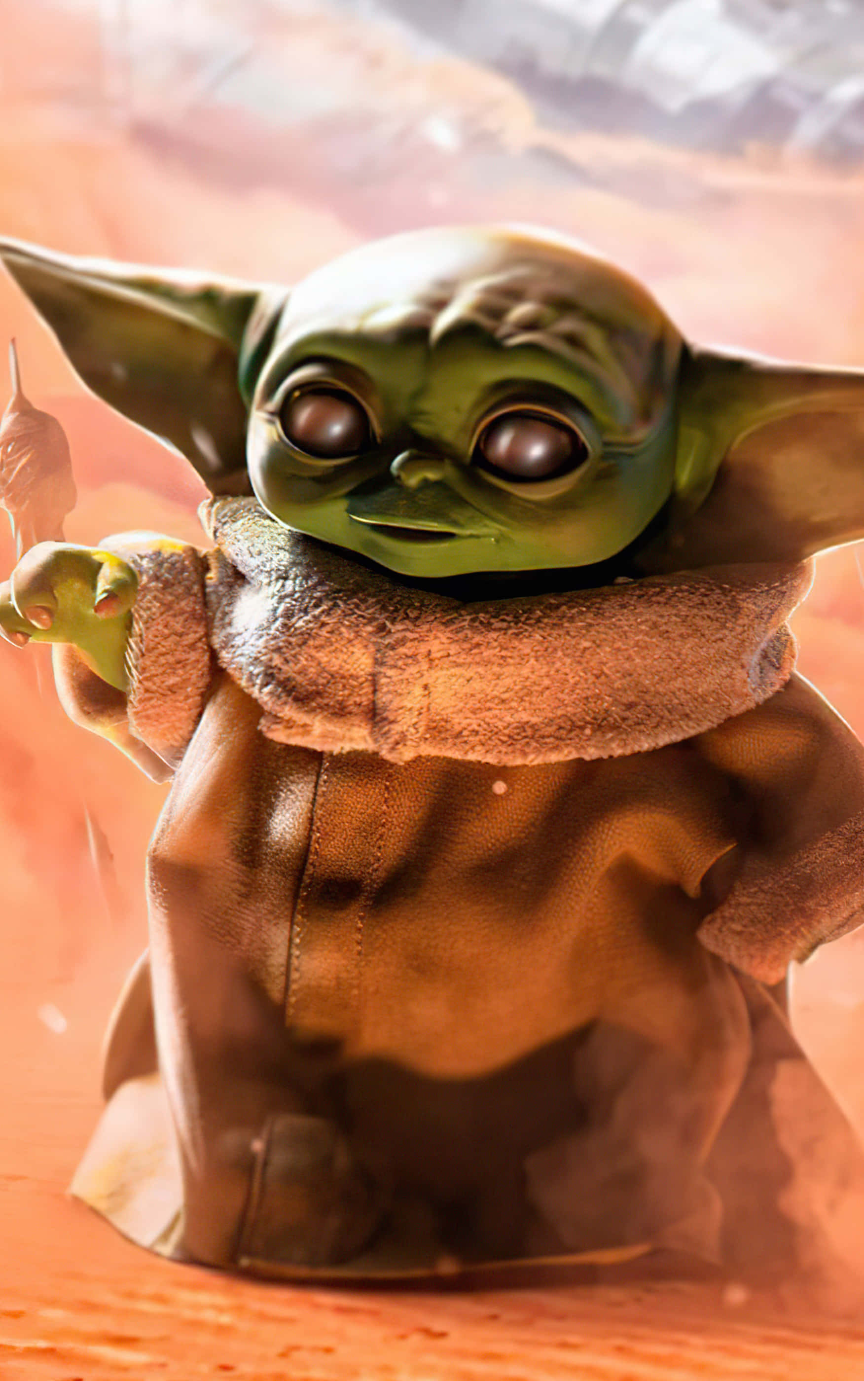 Baby Yoda Phone 桌布 壁紙 — Grogu 綠色小尤達身穿棕色長袍，在溫暖的橙色沙漠背景下手持小杖的特寫。