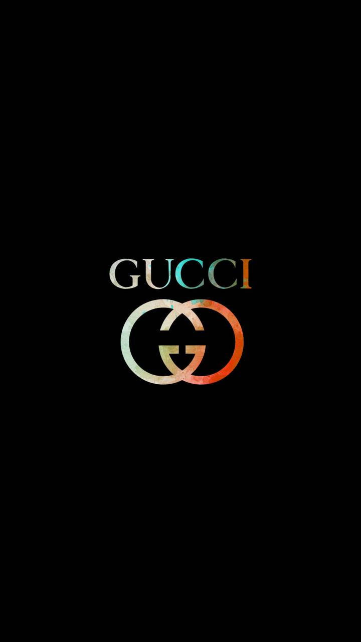 Gucci 桌布 壁紙 — Gucci 標誌以漸變顏色居中於黑色背景上。