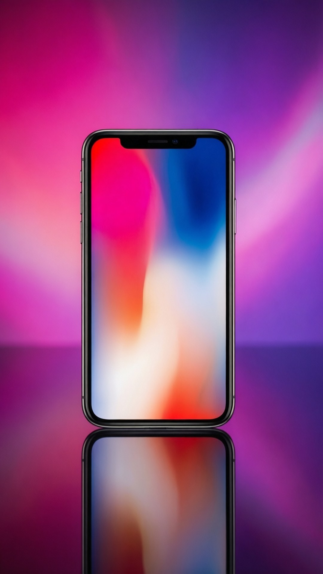 Gradient iPhone X 壁紙 — 一部時尚的黑色智慧型手機，帶有色彩繽紛的抽象螢幕，直立於反光表面上，背景是耀眼的粉紅色和紫色漸層。