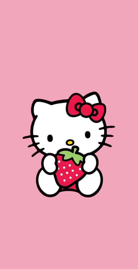 Hello Kitty 在粉紅色背景上拿著草莓。 — Hello Kitty 壁紙
