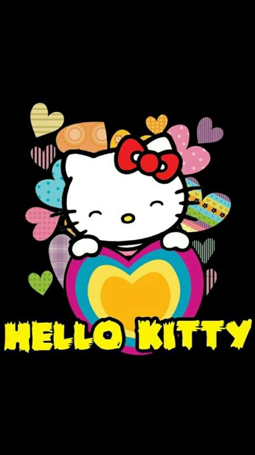  壁紙 — Hello Kitty 卡通角色戴著紅色蝴蝶結，手持彩虹愛心，周圍是彩色圖案愛心，背景為黑色。