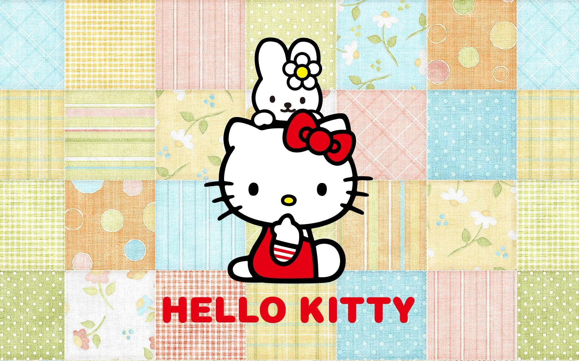 三麗鷗角色 桌布 壁紙 — Hello Kitty 和她的朋友坐在色彩繽紛的拼布被子背景上，帶有花卉和幾何圖案。