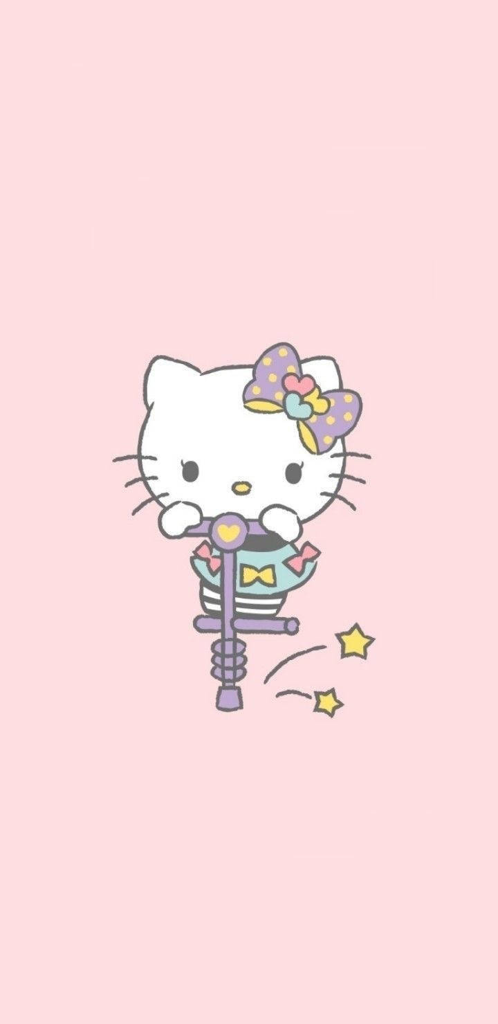 Hello 桌布 壁紙 — Hello Kitty 在柔和粉紅色背景上騎著紫色彈簧棒，帶有閃光效果。