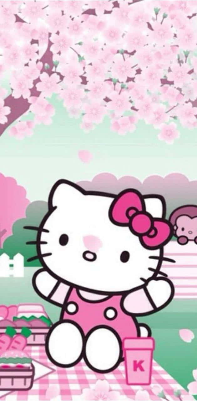 Hello Kitty 桌布 壁紙 — Hello Kitty 在粉紅色櫻花下開心地野餐，有粉紅色蝴蝶結和格子毯。