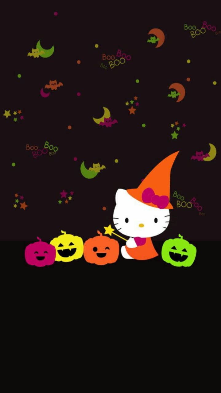 Kitty 桌布 壁紙 — Hello Kitty 戴著巫婆帽，在滿天星斗的萬聖節夜空下，手持魔杖，旁邊有微笑的南瓜燈。