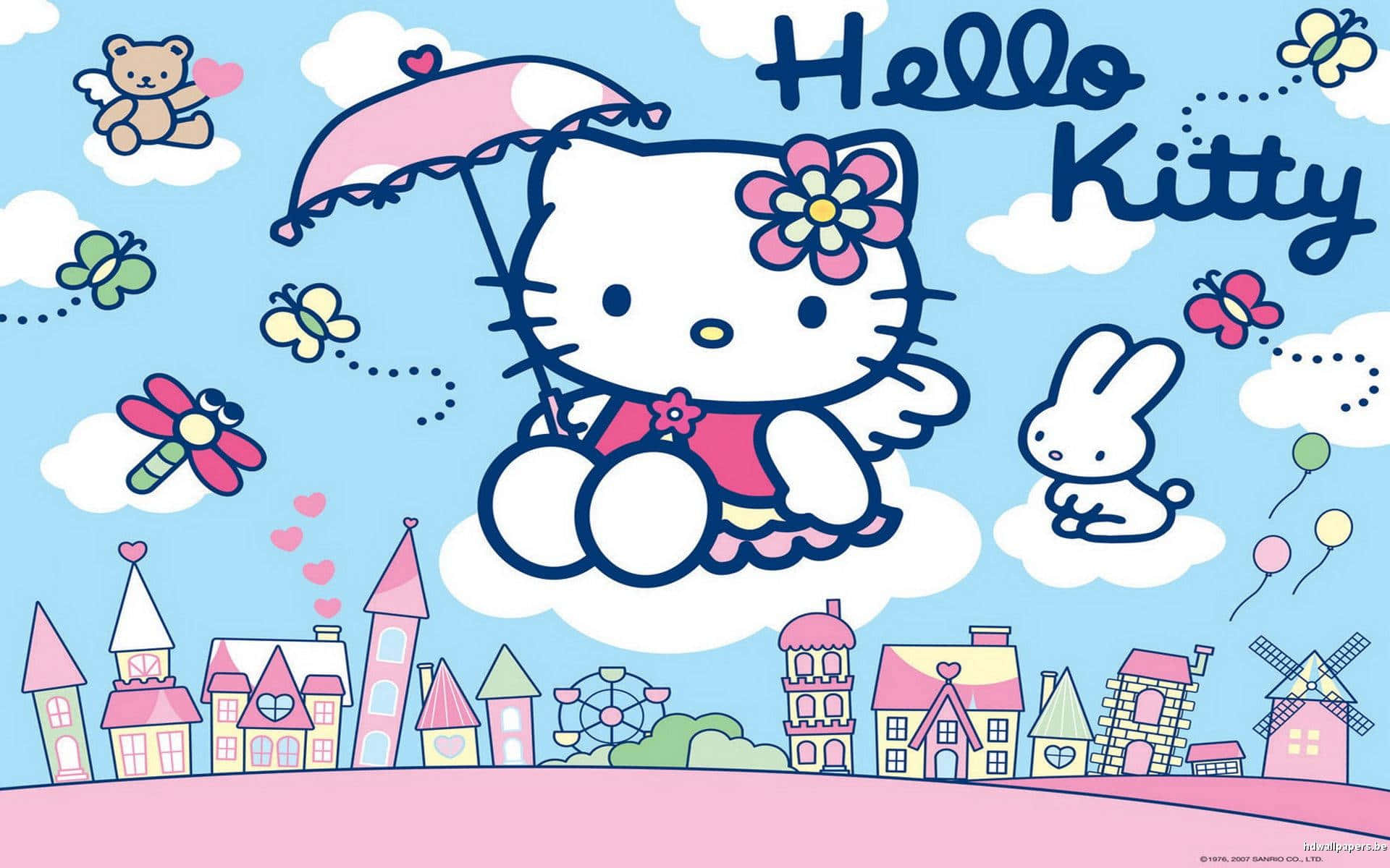 Hello Kitty Pc 桌布 壁紙 — Hello Kitty 拿著粉紅色雨傘，漂浮在一個充滿蝴蝶和泰迪熊的夢幻粉彩小鎮上空。