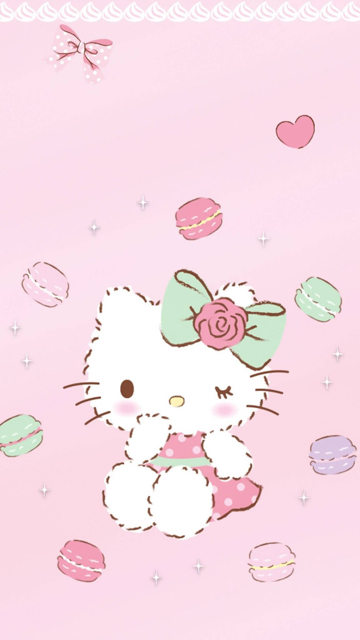Hello Kitty 被馬卡龍和心形圖案環繞在粉紅色背景上 — 三麗鷗角色 GIF 壁紙