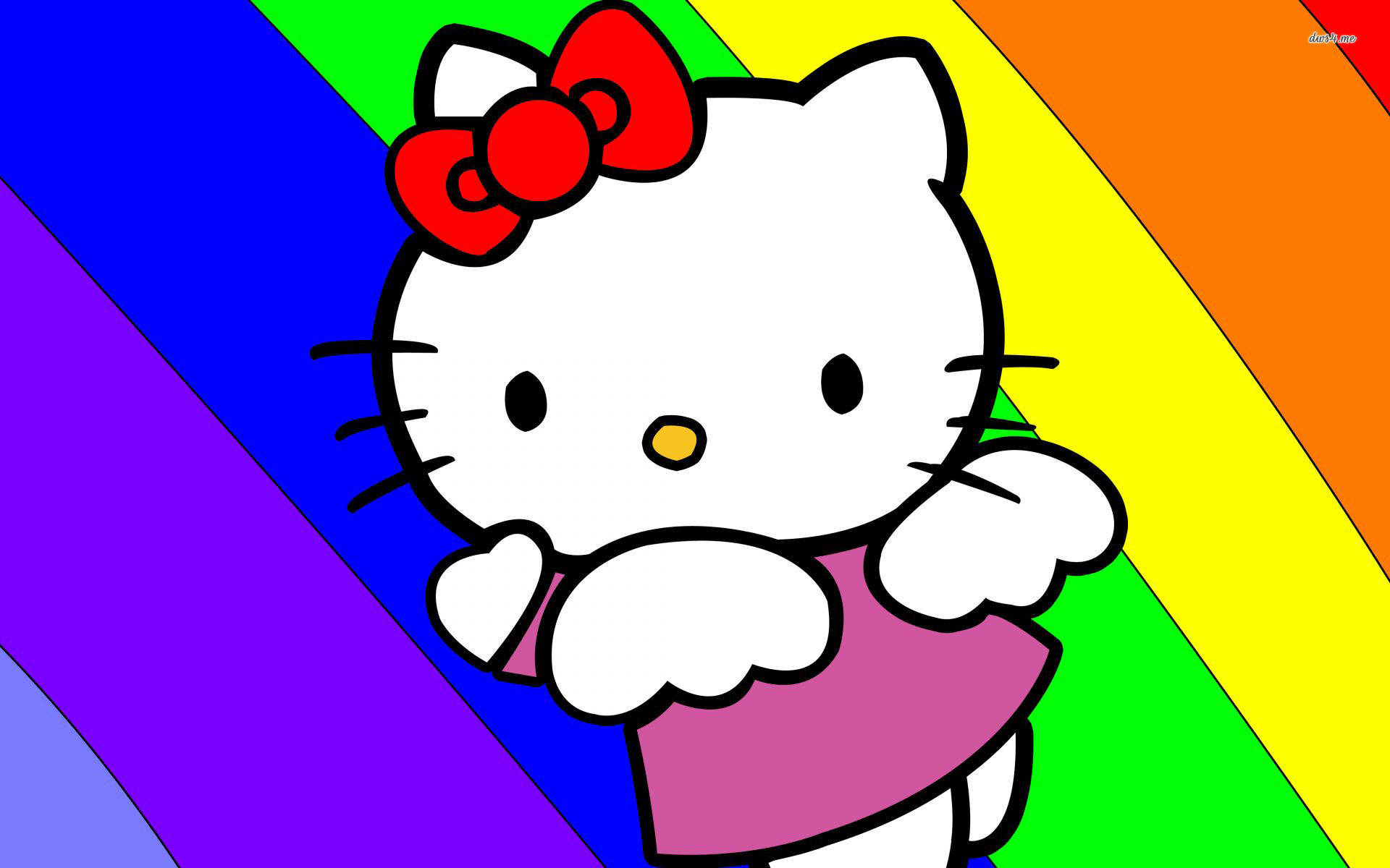 Hello 桌布 壁紙 — Hello Kitty 身穿粉紅色連衣裙，戴著紅色蝴蝶結，站在充滿活力的彩虹對角線背景前。