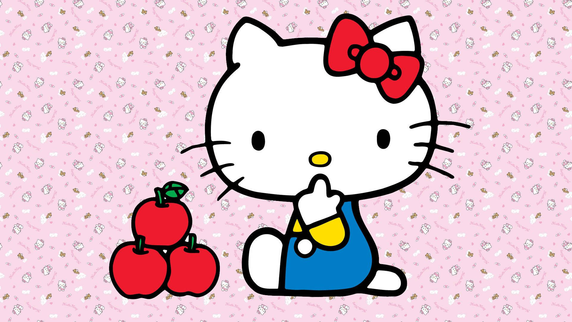 Hello 桌布 壁紙 — Hello Kitty 身穿藍色工裝褲，坐在粉紅色圖案背景上的三個紅蘋果旁邊。
