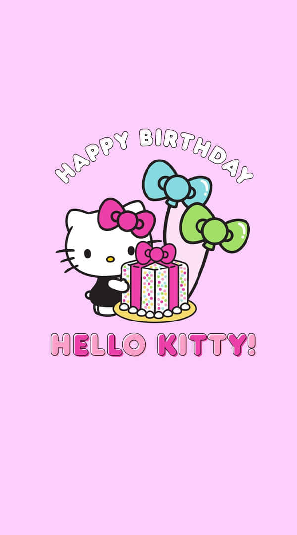 Hello Kitty Birthday 桌布 壁紙 — Hello Kitty 身穿黑色連衣裙，手持一個帶有彩色糖粒和蝴蝶結的粉紅色蛋糕，色彩繽紛的氣球漂浮在柔和的粉紅色背景上。