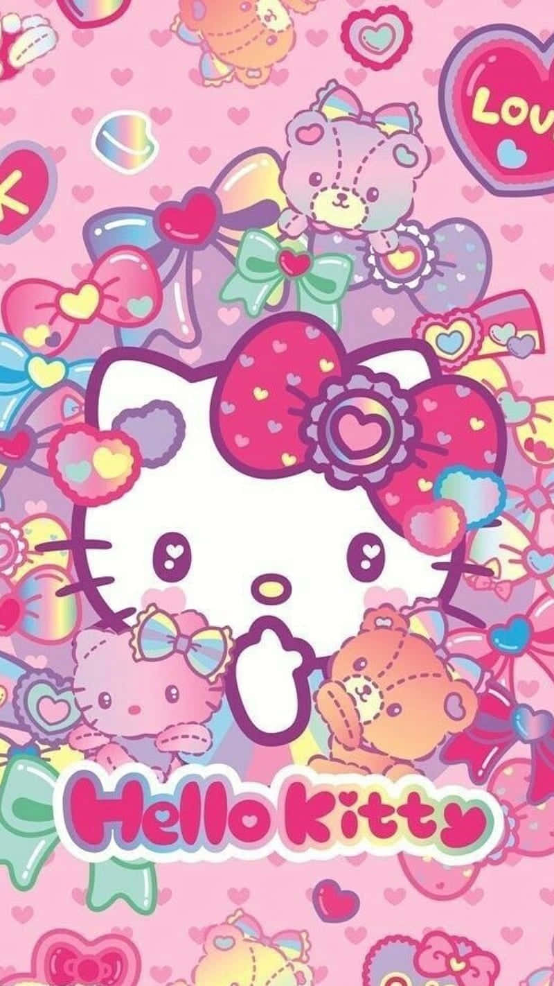 Kawaii Hello Kitty 桌布 壁紙 — Hello Kitty 配彩虹蝴蝶結，被毛絨熊、心形和蝴蝶結包圍，背景為粉紅色。