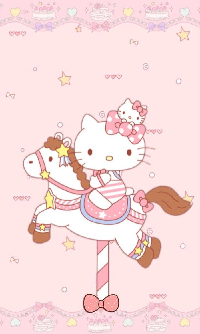 sanrio 桌布 壁紙 — Hello Kitty 騎著一匹裝飾著星星和蝴蝶結的旋轉木馬，背景是帶有蛋糕圖案的粉紅色背景。