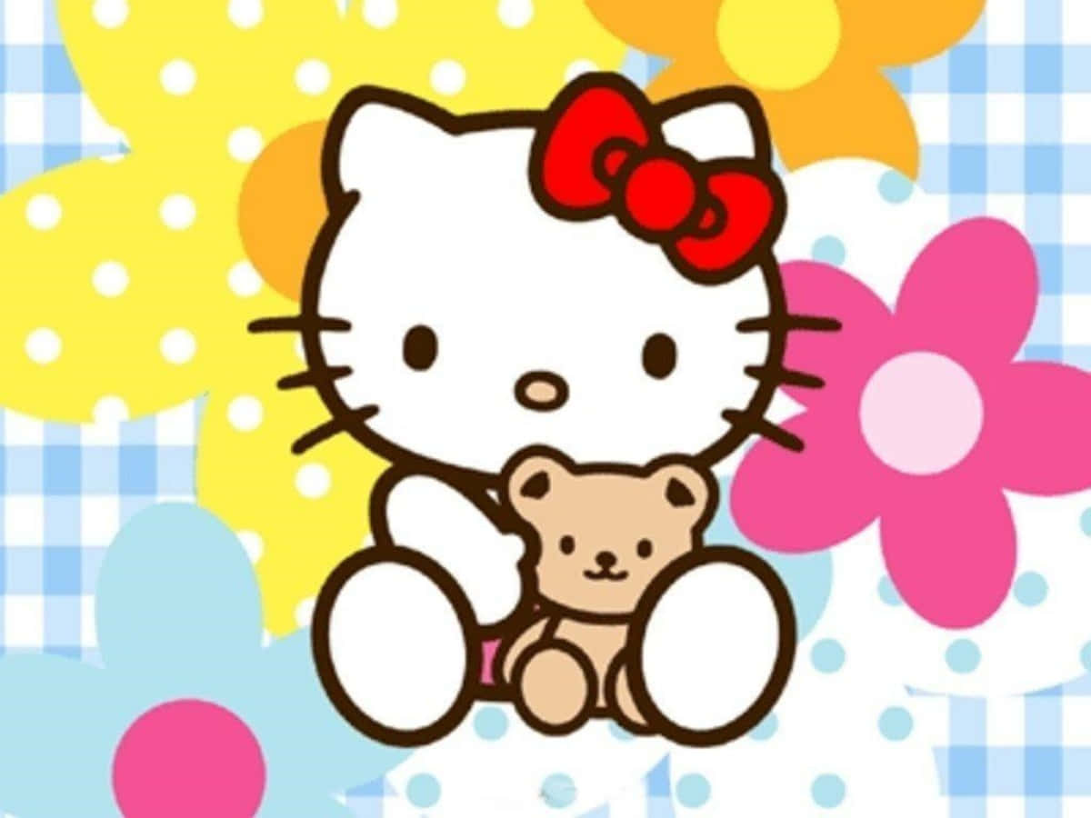 Hello Kitty Laptop 桌布 壁紙 — Hello Kitty卡通角色抱著一隻泰迪熊，周圍環繞著色彩繽紛的花朵和圓點圖案。