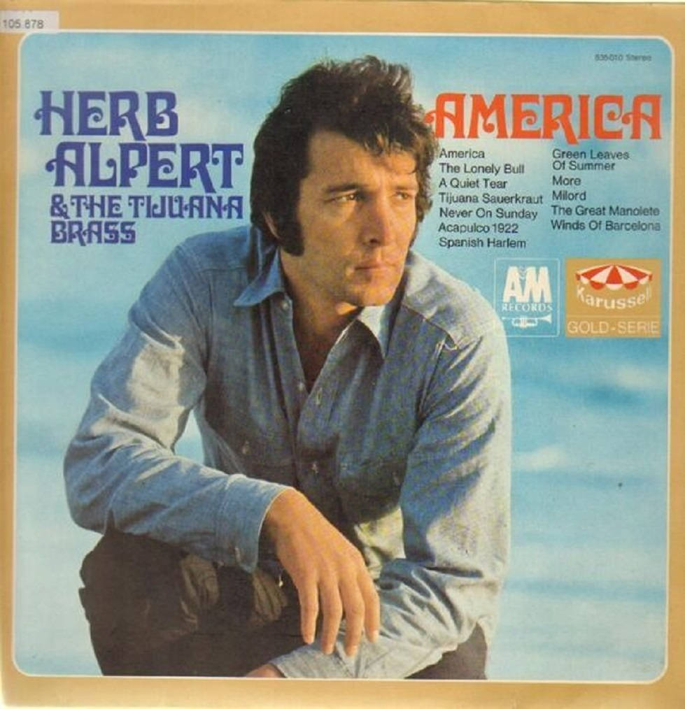 album 桌布 壁紙 — Herb Alpert 身穿藍色襯衫，在America的復古專輯封面上以柔和的藍天為背景擺姿勢。