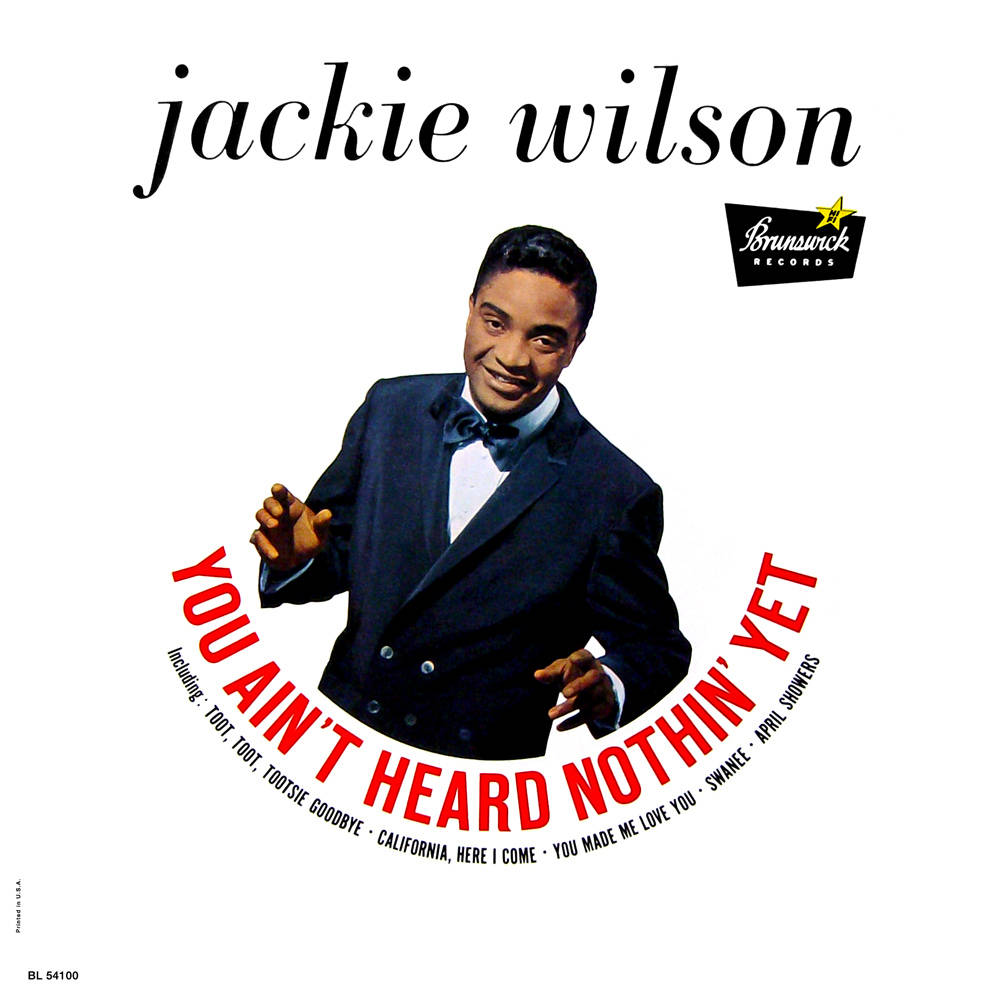 Singer 桌布 壁紙 — Jackie Wilson 身穿俐落燕尾服，在復古 Brunswick Records 專輯封面上自信地咧嘴而笑，搭配粗體紅色字體。