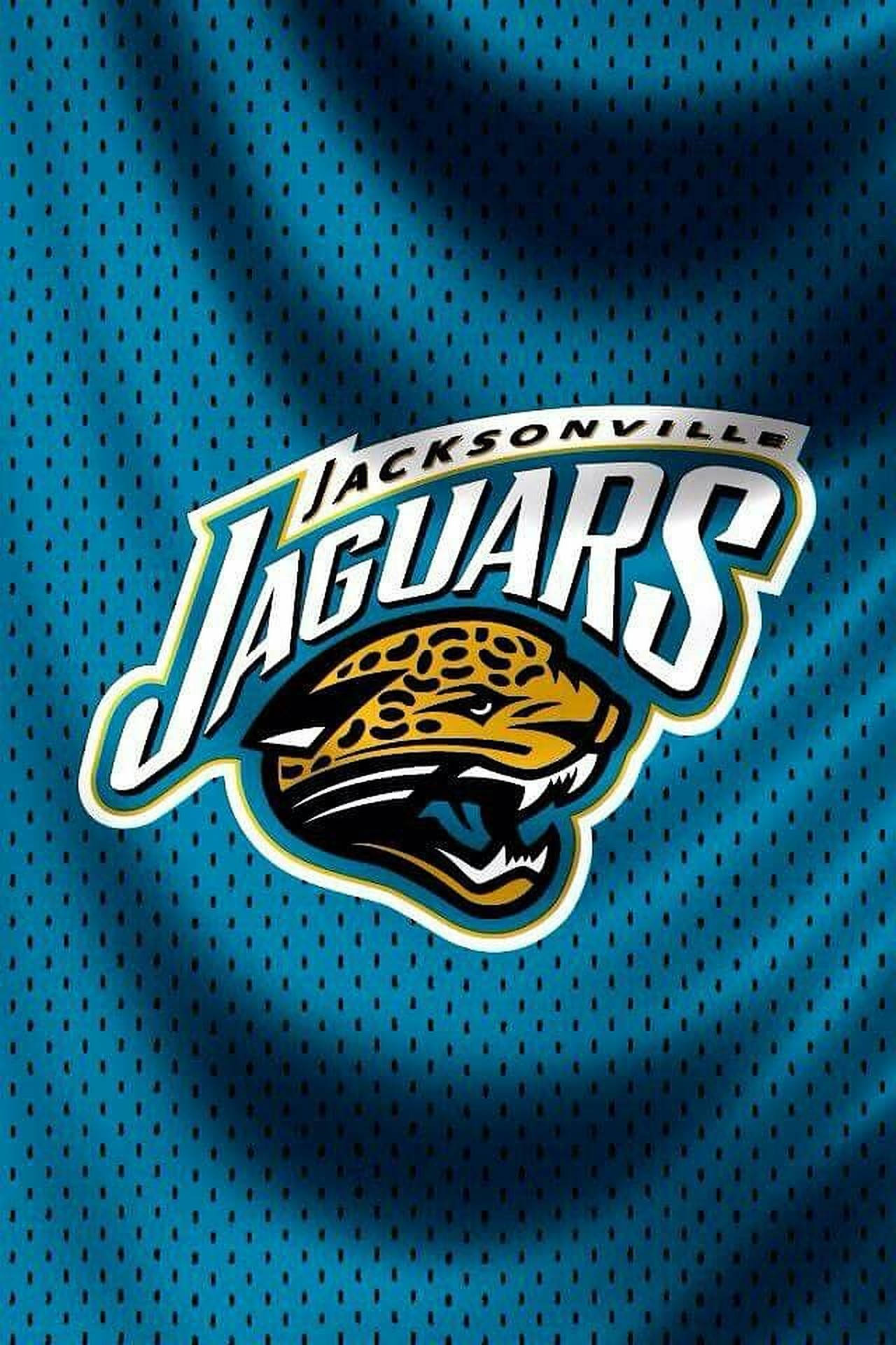 Jaguars 桌布 壁紙 — Jacksonville Jaguars 標誌印在帶有紋理的青綠色美式足球球衣上，搭配戲劇性燈光。
