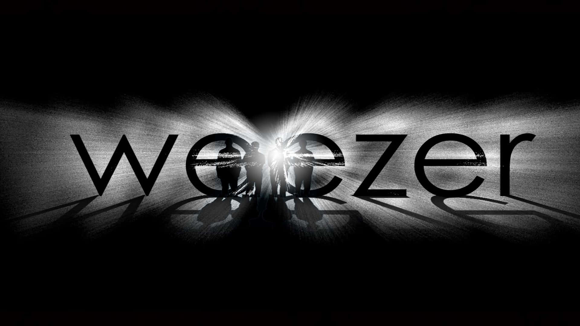  壁紙 — 剪影樂隊成員站在黑暗舞台上，背後有發光的 'weezer' 文字，並帶有戲劇性的背光效果。
