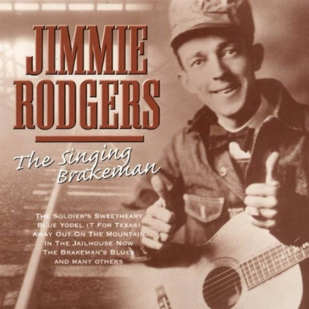 專輯封面 桌布 壁紙 — Jimmie Rodgers 微笑著抱著木吉他並豎起兩個大拇指的復古棕褐色肖像。