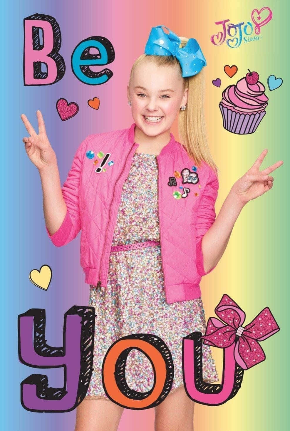 Jojo 桌布 壁紙 — Jojo Siwa 穿著粉紅色外套，在帶有心形和紙杯蛋糕的彩虹背景前燦爛微笑。